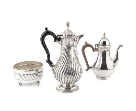 A late Victorian hot water pot, of spirally lobed baluster form, with ebonised handle by Charles Stuart Harris, London 1881, 