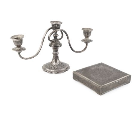 A Persian white metal three light candelabrum, with foliate engraved decoration, marks to base, 18.5cm high, 20oz, and a simi