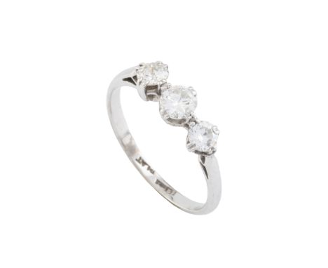 A diamond three stone ring, the slightly graduated round brilliant and old brilliant-cut diamonds in claw setting, white prec