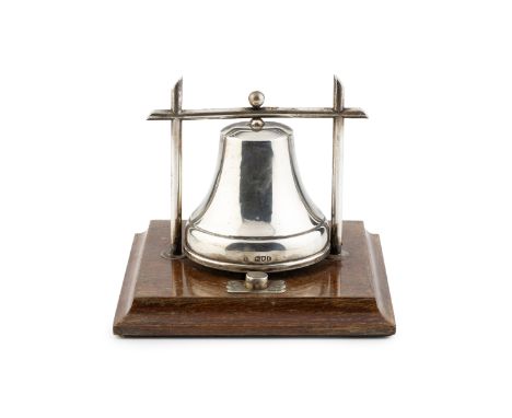 An Edwardian silver table bell, with push button activation, on oak plinth base by George Betjemann &amp; Sons, London 1906, 
