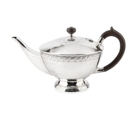 A George V silver teapot, of circular domed form, with repeated stylised engraved decoration and having composite handle and 