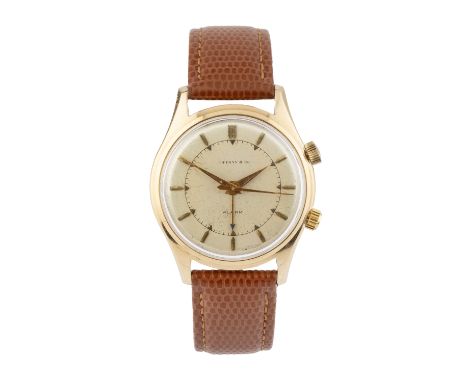 A gentleman's alarm wristwatch by Tiffany &amp; Co., the circular silvered dial with baton markers, inner minute track, centr