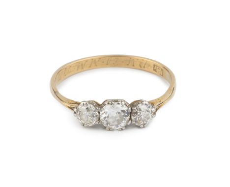 A diamond three stone ring, the graduated old brilliant-cut diamonds in claw setting, with interior inscription, stamped '18c