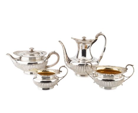 A George V silver four piece tea and coffee service, with gadrooned, foliate and mask borders and half lobed bodies, the teap
