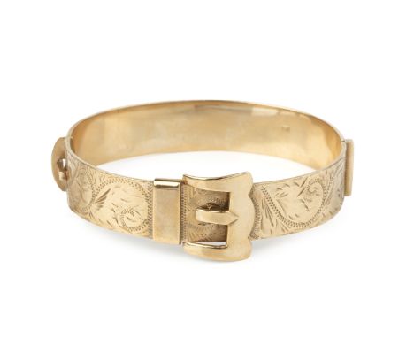 A 9ct gold bangle, of hinged oval form, modelled as a belt buckle, with foliate engraved decoration, width 6.5cmGross weight 