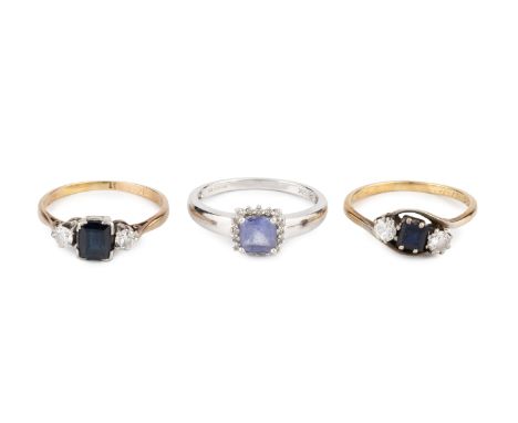 A sapphire and diamond three stone ring, the rectangular step-cut sapphire flanked by two round brilliant-cut diamonds, with 