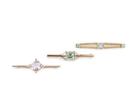 An aquamarine and seed pearl bar brooch, the trio of graduated step-cut aquamarines to an elongated lozenge-shaped panel, spa