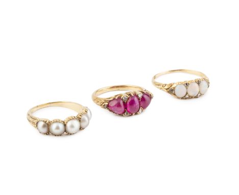 A ruby three stone ring, the graduated cabochon rubies spaced by rose-cut diamond points, to a scroll decorated mount, togeth