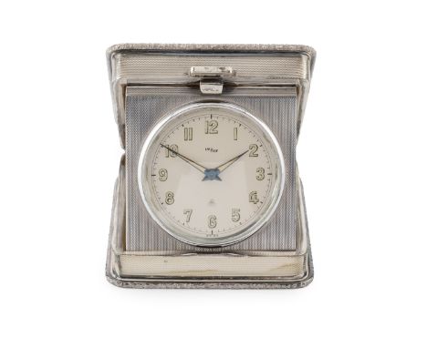 A silver travelling timepiece, the engine turned square section folding case with foliate cast borders, and having circular s