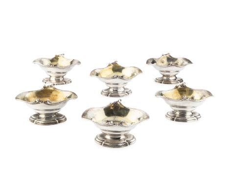 Six early George III silver pedestal salts, of shaped oval double-lipped form, having gadrooned borders and gilt interiors, b
