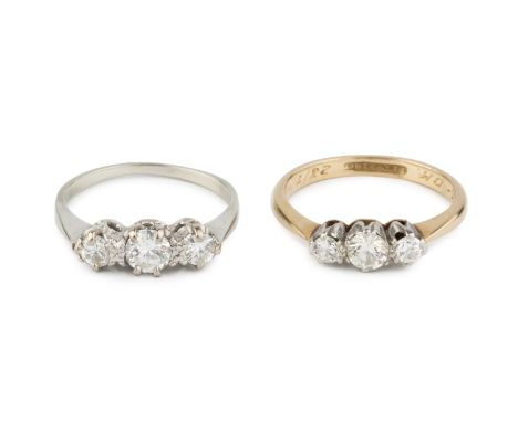 A diamond three stone ring, the graduated stones in claw setting, inscribed to interior, stamped 'PLAT &amp; 18CT', together 