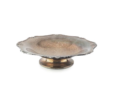 A George V silver fruit stand, of shaped outline with foliate scroll and scallop border, on low pedestal foot by Goldsmiths &