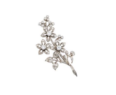 A diamond floral spray brooch, designed as a trio of round brilliant and single-cut diamond set flowerhead clusters, issued f