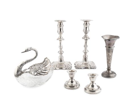 A pair of late Victorian silver candlesticks, with shaped and knopped stems and weighted square section bases by I. S. Greenb