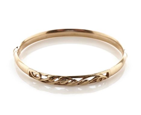 A 9ct yellow gold bangle, with Art Nouveau style pierced foliate decoration, 72mm wide, 11.1g gross.