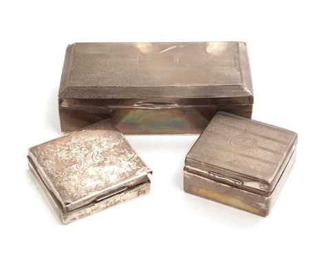 An Art Deco silver cigarette box, Birmingham 1934, with engine turned decoration, 18cms wide; and two smaller silver cigarett