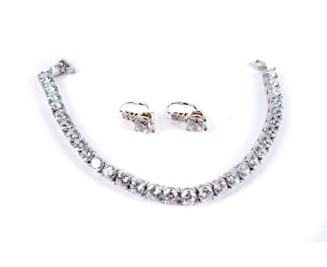 A white stone tennis bracelet; and a pair of white stone and silver drop earrings, stamped '925'. (2)