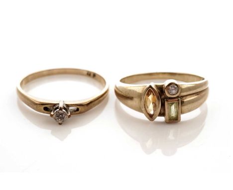 A coloured gem stone ring, set with a marquise cut citrine, a baguette cut peridot and a round brilliant cut white stone, in 