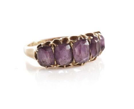 An amethyst five stone dress ring, set with graduated faceted oval amethysts, in 18ct yellow gold, size K, 4.7g gross.
