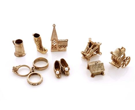A collection of 9ct yellow gold charms, including: a carriage; a church; a lantern; and other items, 27.0g gross; together wi