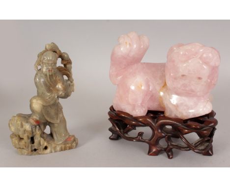 A 20TH CENTURY CHINESE ROSE QUARTZ MODEL OF A BUDDHISTIC LION, together with a fitted wood stand, 6.2in high overall, the ros