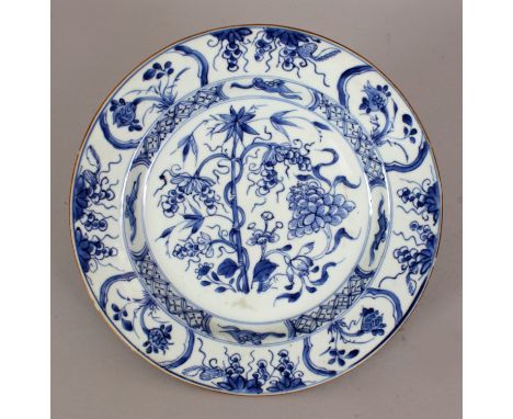 A CHINESE KANGXI/YONGZHENG PERIOD BLUE & WHITE PORCELAIN PLATE, painted to its centre with bamboo, peony and vine, the rim wi