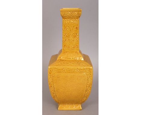 A CHINESE YELLOW GLAZED PORCELAIN VASE, the square section body decorated with panels of dragons amidst cloud and flame scrol