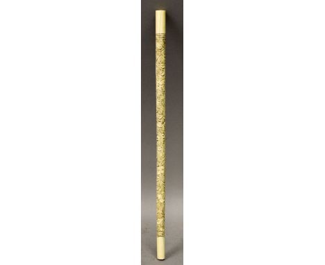 A 19TH/20TH CENTURY CHINESE CARVED IVORY STICK, decorated in low relief with scrolling foliage, 11.5in long.