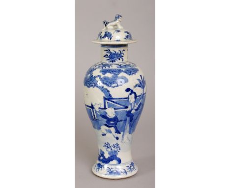 A 19TH CENTURY CHINESE BLUE & WHITE PORCELAIN VASE & COVER, the sides painted with a lady and boys in a fenced garden setting