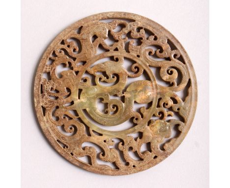 A CHINESE PIERCED CIRCULAR JADE PLAQUE, decorated with dragons, 4.3in diameter.
