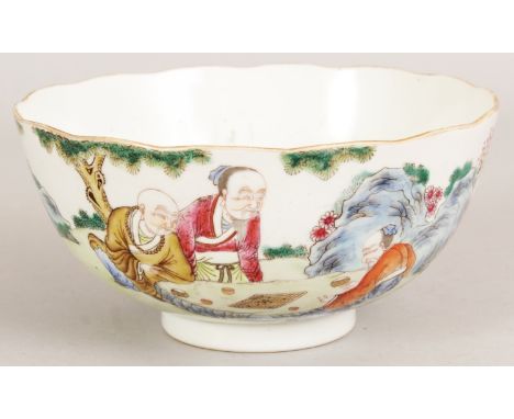 A GOOD QUALITY CHINESE FAMILLE ROSE PORCELAIN BOWL, the sides painted with a rock-strewn garden scene of sages playing Go, th