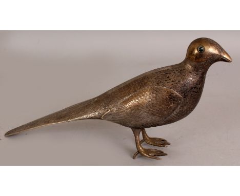 A 19TH/20TH CENTURY PERSIAN SILVERED METAL MODEL OF A STANDING BIRD, its coat naturalistically engraved, its eyes inlaid with