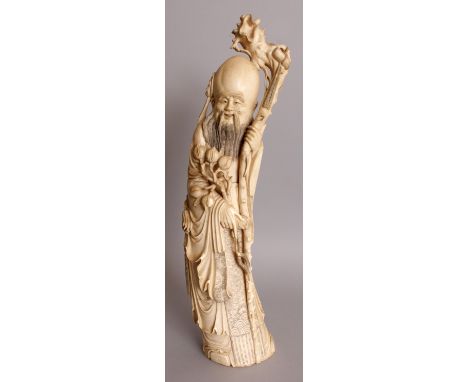 A GOOD EARLY 20TH CENTURY CHINESE CARVED IVORY TUSK FIGURE OF SHOU LAO, weighing 2.24Kg, the deity with cheerful expression h