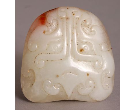 A CHINESE WHITE JADE CARVING, each side with an archaic taotie mask, the stone with russet inclusions, 2.1in wide and also 2.