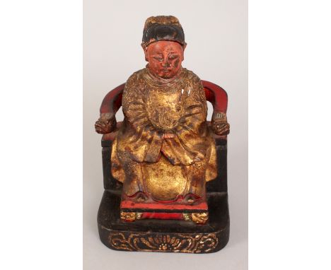 A 19TH CENTURY CHINESE GILT & LACQUERED WOOD MODEL OF A SEATED OFFICIAL, on a throne like chair, the reverse with an inscript