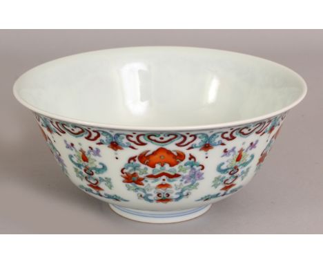 A CHINESE DOUCAI PORCELAIN BOWL, the sides decorated with alternating formal floral arrangements, the base with a Qianlong se