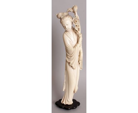 AN EARLY 20TH CENTURY SIGNED CHINESE CARVED IVORY FIGURE OF A STANDING LADY, together with a fixed wood stand, the figure dre