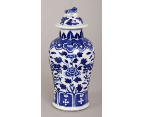 A 19TH CENTURY CHINESE BLUE & WHITE PORCELAIN DRAGON VASE & COVER, painted with two confronting dragons amidst peony & foliag