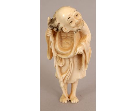 AN EARLY 20TH CENTURY IVORY NETSUKE OF A STANDING SENNIN, carved in a retrospective style, 2.5in high.