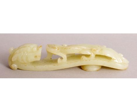 A CHINESE CELADON JADE BELT HOOK, of traditional form, 4.2in long.