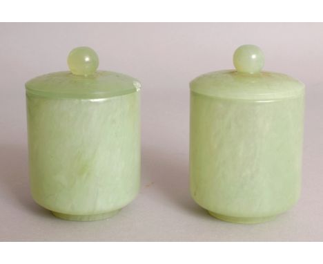 A PAIR OF 20TH CENTURY CHINESE CELADON JADE LIKE CIRCULAR POTS & COVERS, each 3.4in high overall & 2.25in diameter at rim.
