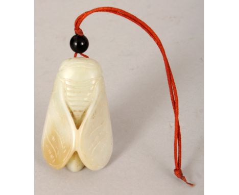 A CHINESE CELADON JADE MODEL OF A MOTH, together with a cord and attached hardstone bead, the jade 1.75in long.