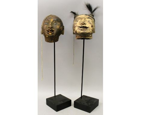 AN UNUSUAL PAIR OF 19TH CENTURY CHINESE LACQUERED WOOD PUPPET HEADS, mounted on stands, 17.5in & 17in high overall, the heads