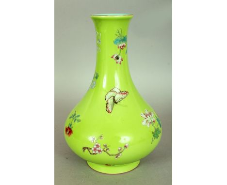 A GOOD QUALITY CHINESE LIME GREEN GROUND FAMILLE ROSE PORCELAIN VASE, decorated with butterflies and loose floral sprays, the