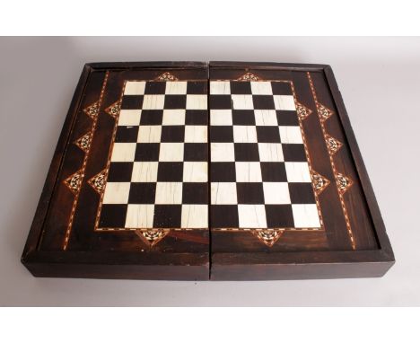 A 19TH/20TH CENTURY NEAR EASTERN IVORY & EBONY INLAID FOLDING CHESS AND BACKGAMMON BOARD, 18.4in x 10.75in x 4.1in high.