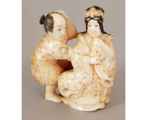 A JAPANESE MEIJI PERIOD CARVED IVORY NETSUKE OF A MAN & A BIJIN, the man clasping at her robe, 1.6in high.