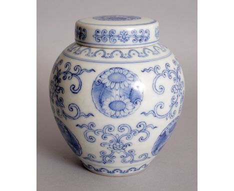 A CHINESE BLUE & WHITE PORCELAIN JAR & COVER, decorated with repeated motifs of floral roundels and of scrolling lotus, the b