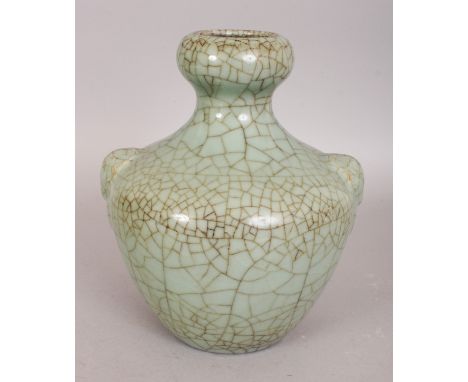 A CHINESE CELADON CRACKLEGLAZE PORCELAIN VASE, the squat ovoid body moulded with double archaic mask and ring handles, the ba