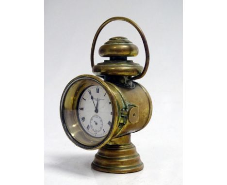 An ornate miniature Edwardian brass motorcar side lamp, housing a superb Sir John Bennett Ltd pocket watch movement. It is be