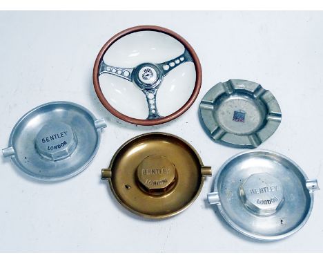 A good lot, comprising three Bentley Motors ashtrays, one RREC badged ashtray and a Les Leston ceramic ashtray. Varied condit